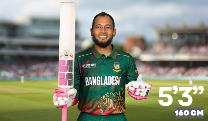 A smiling cricket player wearing a Bangladesh jersey holds a pink-and-white cricket bat and gloves on a sunny cricket field